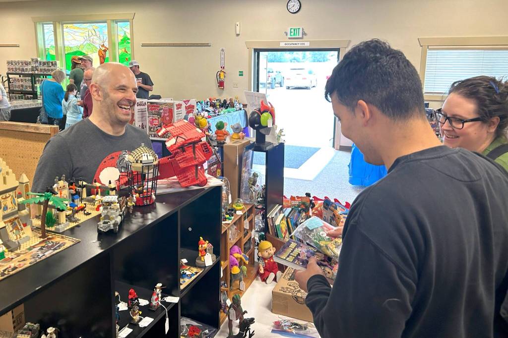 Corey Edwards, organizer of the Olympic Peninsula Toy and Collectibles Show, chats with visitors of the show on Aug. 30. Hes planning to add more spaces to the show in 2026 while keeping it in the Guy Cole Event Center.