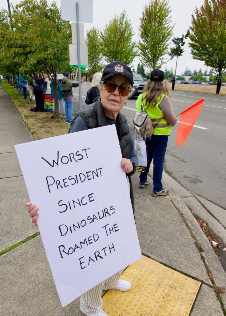 Vivien Smith of Sequim displays her sign.