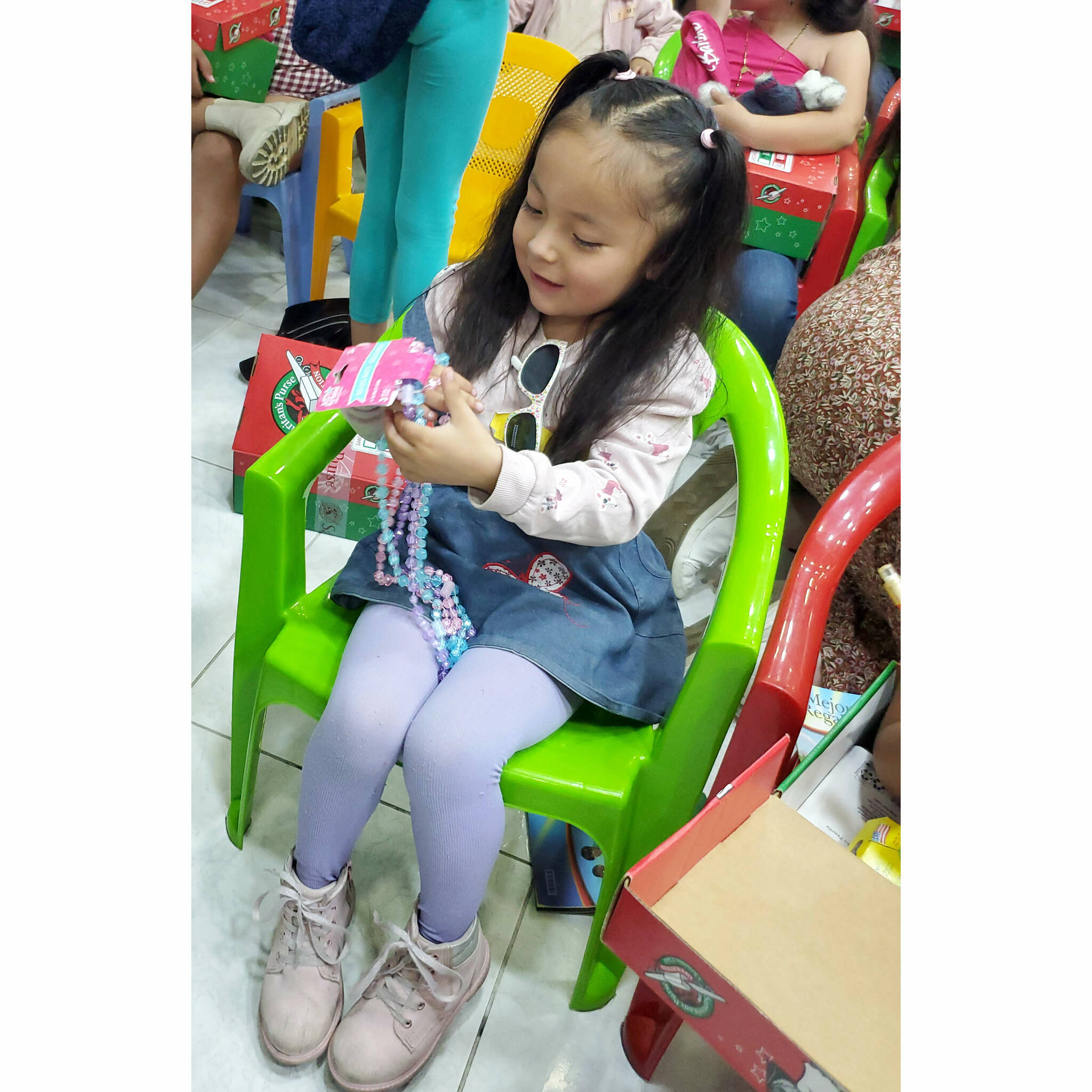 Photo courtesy of Samaritans Purse/Operation Christmas Child A little girl in Quito, Ecuador enjoys one of the shoe box toys she received from Operation Christmas Child. Locals can learn how to assist in the global initiative at an Open House scheduled for Saturday, Sept. 13 at Eastern Hills Community Church in Carlsborg.