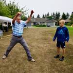 John Buchser, left, tries to win the Hula Hoop contest at Saturdays picnic for the Sunland community as Caden Dyck, right, eyes his moves. The winner was entered into a drawing for a free round of golf at Sunland Golf Course.