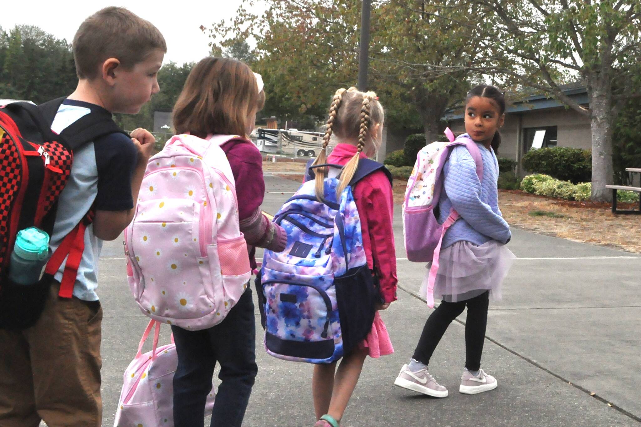 Sequim Gazette photo by Matthew Nash
Natalie Ramirez leads the line of kindergartners in Sarah Wilhelms class who were dropped off for the first day of school on Sept. 2