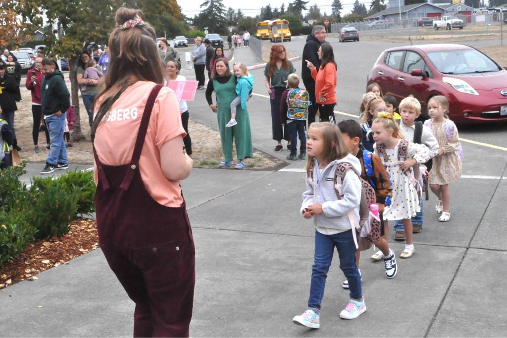 Sequim Gazette photo by Matthew Nash
Kindergarten teacher Amy Skogsberg at Greywolf Elementary leads some of her students into school on Sept. 2.