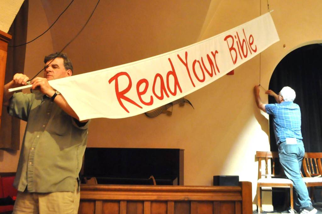 Sequim Gazette photo by Matthew Nash/ A banner encouraging visitors to the courthouse in Read Your Bible goes up in Inherit the Wind.