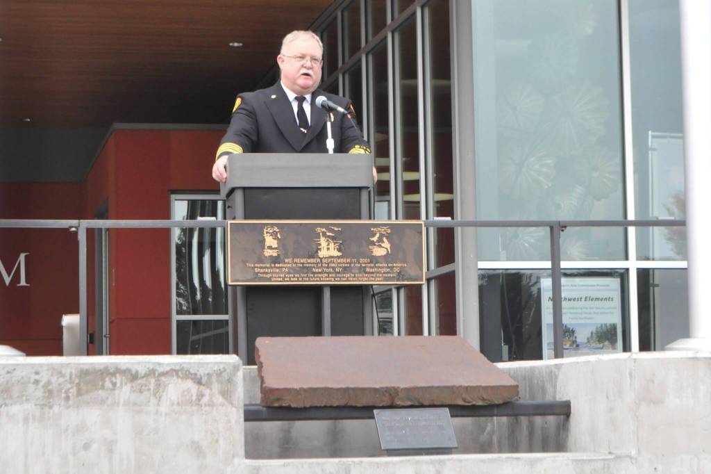 Sequim Gazette photo by Matthew Nash/ Fire Chief Justin Grider with Clallam County Fire District 3 speaks at a 9/11 Remembrance Ceremony saying new firefighters born after the tragedy carry forward the legacy of service, and even without a personal memory of that solemn day, their commitment to wearing the badge symbolizes continuity and a pledge to never forget those who were lost.
