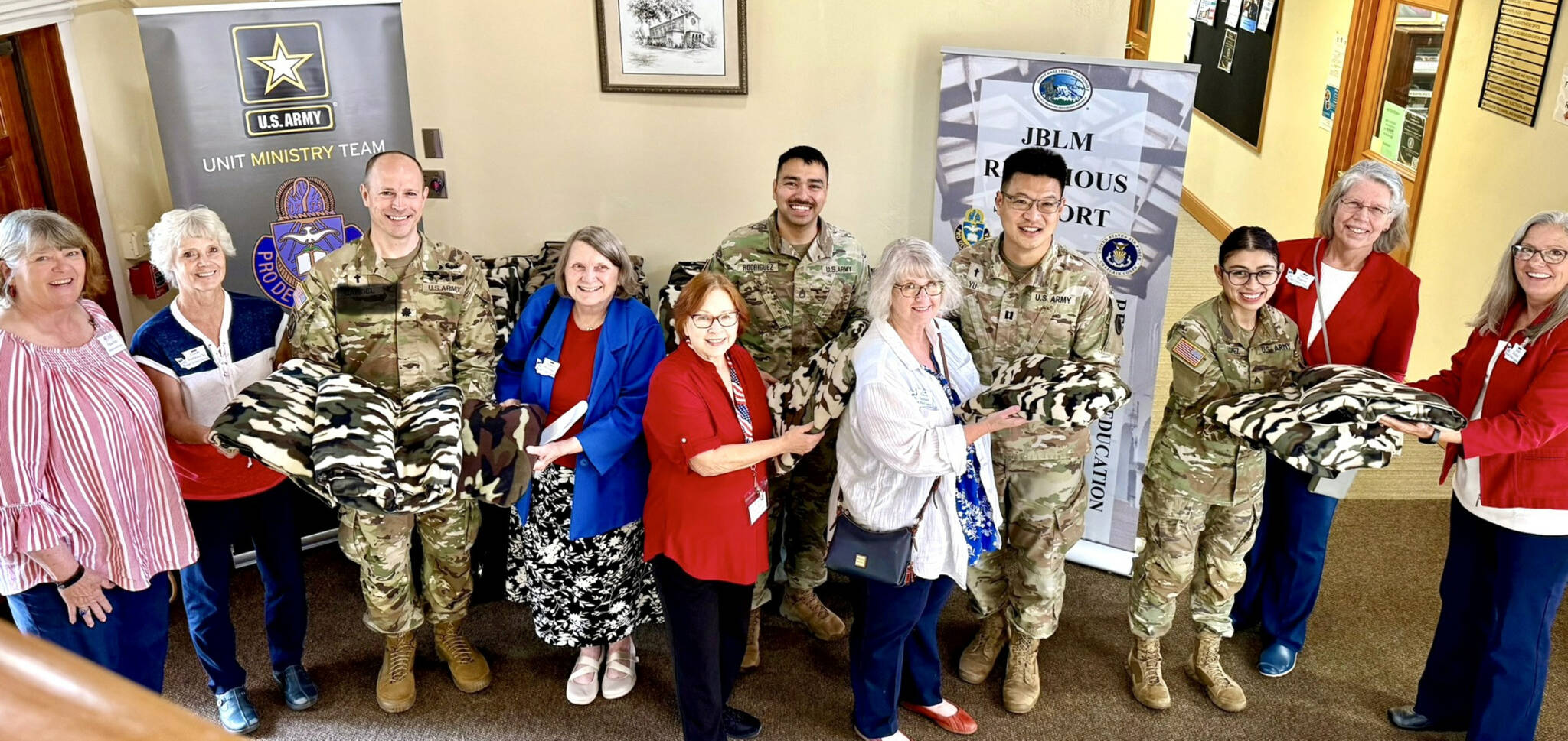 Photo courtesy Michael Trebert Chapter DAR
Service members at Joint Base Lewis-McChord near Tacoma gratefully accept the gifts of 38 handmade blankets and 108 protein snacks from members of the Michael Trebert Chapter, DAR.