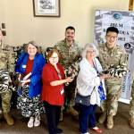 Photo courtesy Michael Trebert Chapter DAR
Service members at Joint Base Lewis-McChord near Tacoma gratefully accept the gifts of 38 handmade blankets and 108 protein snacks from members of the Michael Trebert Chapter, DAR.