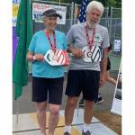 Photo courtesy of Susan Lewis
Eighty-one-year-old Beverly Hoffman and her doubles partner Steve Bennett show off the medals they won in a pickleball tournament.