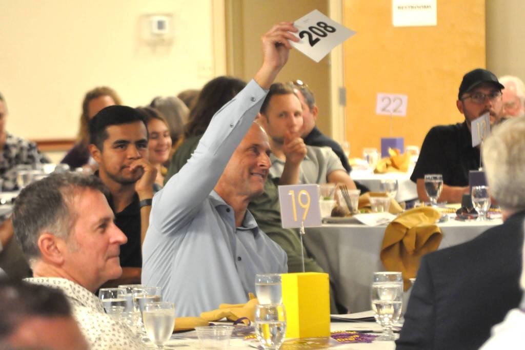 Sequim Gazette photo by Matthew Nash
Ryan Kaps, a Sequim High School Hall of Fame 2024 inductee, bids on a basketball he and teammates of the 1988 varsity basketball team signed during their state run. He and teammates were inducted into the Hall of Fame this year for finishing second at state.