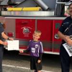 Photo courtesy Clallam County Fire District 3
Through Sept. 30, children ages 3-12 can participate in a contest to highlight Fire Prevention Week (Oct. 5-11). Children ages 3-6 can color a firetruck and older kids can diagram escape routes for their familys home. Here, Dash Anderson shows off his coloring skills to firefighters Libby Swanberg and Jared Kneidl. Pick up the coloring and diagram sheets at Hi-Way 101 Diner (no purchase necessary), 392 W. Washington St., or at the Sequim Gazette, 175 W. Washington St. The contest is sponsored by the Gazette, Hi-Way 101 Diner and Clallam County Fire District 3.