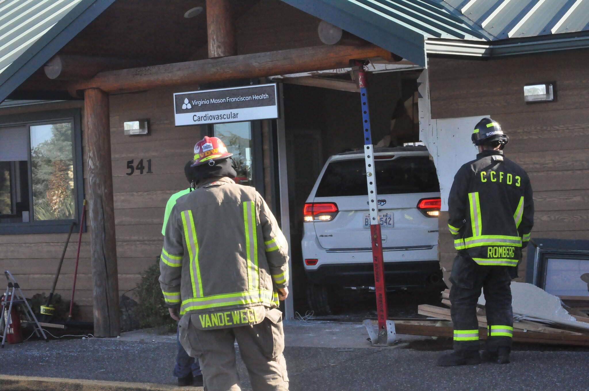 Sequim Gazette photo by Matthew Nash/ Clallam County Fire District 3 firefighters maneuver a Jeep out of a building on Monday morning after it was driven fully into the space.