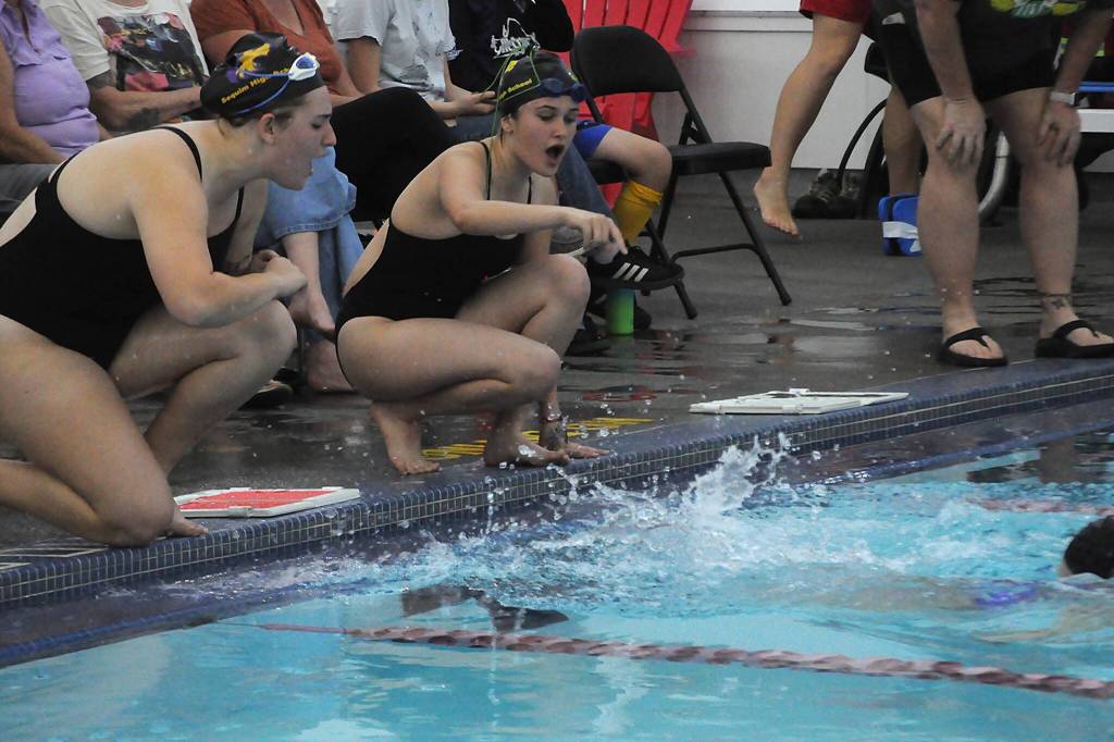 Sequim Gazette photo by Matthew Nash/
Sequim swimmers Madelyn Bower and Grace Bravo cheer for a teammate during a match against Klahowya on Sept. 24 in the Sequim YMCA.