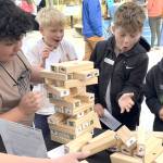 Sequim Gazette photos by Matthew Nash
At the Dungeness River Festival, Helen Haller Elementary third graders, from left, David Hernandez, Kenny Johnson, Calvin Crews, and Carson Holland watch their blocks fall while playing a game with National Park Service staff learning about the importance of salmon in an ecosystem.