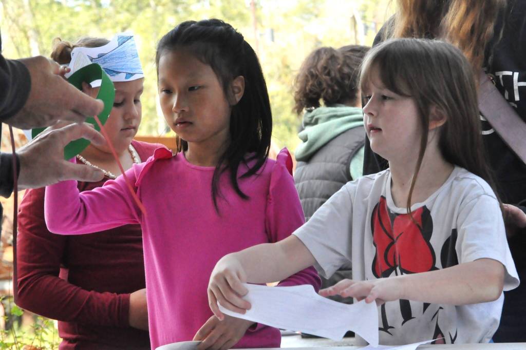 Sequim Gazette photo by Matthew Nash/
Third graders Sierra Simonsen, Cindy Li, and Emma Muck make salmon hats courtesy of the Jamestown SKlallam Tribe.