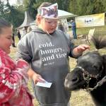 Fifth graders Chloe Corral and Marley Dockery greet Snickers the miniature horse during a visit with the Back Country Horsemen of Washington Peninsula Chapter.