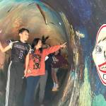 Sequim Gazette photo by Matthew Nash/ Gunner Giddings and Jillian Merrigan and fellow fifth graders climb inside Fin the Migrating Salmon courtesy of the North Olympic Salmon Coalition. The salmon model with a watershed-themed mural inside was a popular attraction at the Dungeness River Festival.