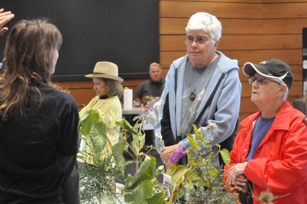 Sequim Gazette photo by Matthew Nash/ Pam Foss and Donna Criscione visit various booths at the Dungeness River Festival, including the Clallam County Noxious Weed Boards booth. It was their first time visiting the festival, they said. Its good to see all these kids here, Foss said.