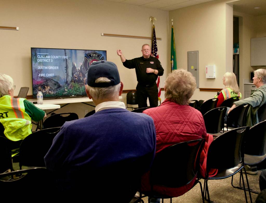 Fire Chief Justin Grider with Clallam County Fire District 3 chats with the audience at the Clallam County Public Safety Fair on Oct. 4 about his experiences with wildfires, including Los Alamos County in New Mexico, and lessons learned from them. He highlighted the importance of preparedness, such as creating defensible spaces using fire-resistant materials, and having evacuation plans.