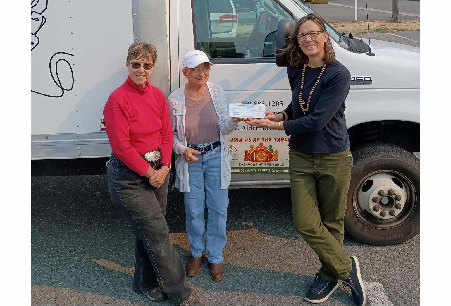 Jen Colmore, right, community engagement coordinator for Sequim Food Bank, accepts a donation of $2,150 from Soroptimist International of Sequim. The check was presented by Natasha Merkkuloff-Nichols, left, the organization's president-elect, and Sandy Lawrence, its treasurer.