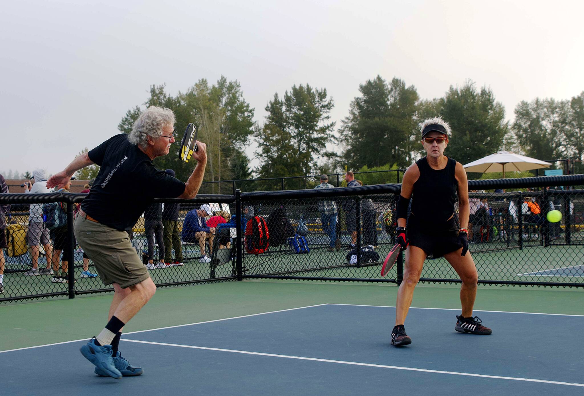 Don Church and Pauline Geraci play an energetic set of mixed doubles during the Sequim Picklers recent Blue Hole Bash pickleball tournament. The round-robin matches included mens and womens singles and doubles as well as mixed doubles at several skill and age levels.