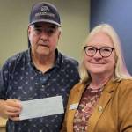Stephen Rosales, left, acting on behalf of the Boys & Girls Clubs of the Olympic Peninsulas Sequim location, accepts a check in the amount of $1,400 from Roxann Harr, president of Soroptimist International of Sequim. The money will be used to buy new chairs needed for the club.