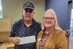 Stephen Rosales, left, acting on behalf of the Boys & Girls Clubs of the Olympic Peninsulas Sequim location, accepts a check in the amount of $1,400 from Roxann Harr, president of Soroptimist International of Sequim. The money will be used to buy new chairs needed for the club.