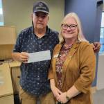 Stephen Rosales, left, acting on behalf of the Boys & Girls Clubs of the Olympic Peninsulas Sequim location, accepts a check in the amount of $1,400 from Roxann Harr, president of Soroptimist International of Sequim. The money will be used to buy new chairs needed for the club.