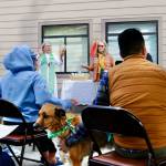 Rev. Dr. Desi Larson (middle, left) sings with Gwen MacRae (middle right) along with David Ham (right) and Rev. Larsons dog Buster, a Heeler/Cattledog (middle) sing a hymn written by St. Francis called All Gods Creatures. St. Frances was believed to have an uncanny ability to communicate with animals, and his deep understanding of our relationship to them is celebrated in the Blessing of the Animals.