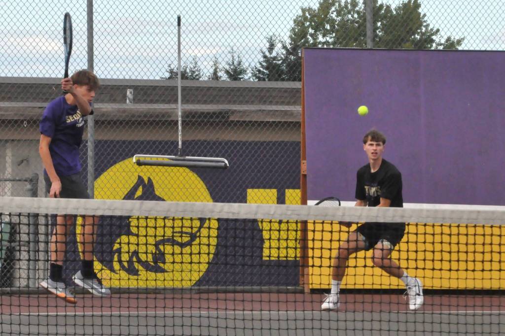 Sequim Gazette photo by Matthew Nash/ Doubles team Bjorn Henrikson and Mason Rapelje return a ball against their North Mason opponents on Oct. 2. They won 6-3, 6-3.