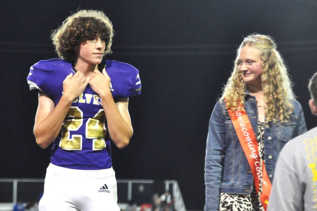 Sequim Gazette photo by Matthew Nash/ Freshmen Silas Hagar and Kendall Adolphe stand together as theyre announced to the crowd at the Homecoming game on Oct. 3 as their class representatives on the annual events royalty court.