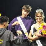 Sequim Gazette photo by Matthew Nash/ Finn Braaten awaits his kings crown from ASB adviser Sean OMera at the Oct. 3 Homecoming game as queen Ashton Reichner looks on.