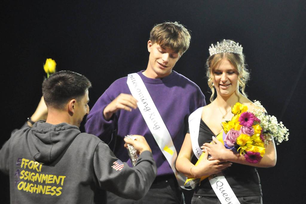 Sequim Gazette photo by Matthew Nash/ Finn Braaten awaits his kings crown from ASB adviser Sean OMera at the Oct. 3 Homecoming game as queen Ashton Reichner looks on.