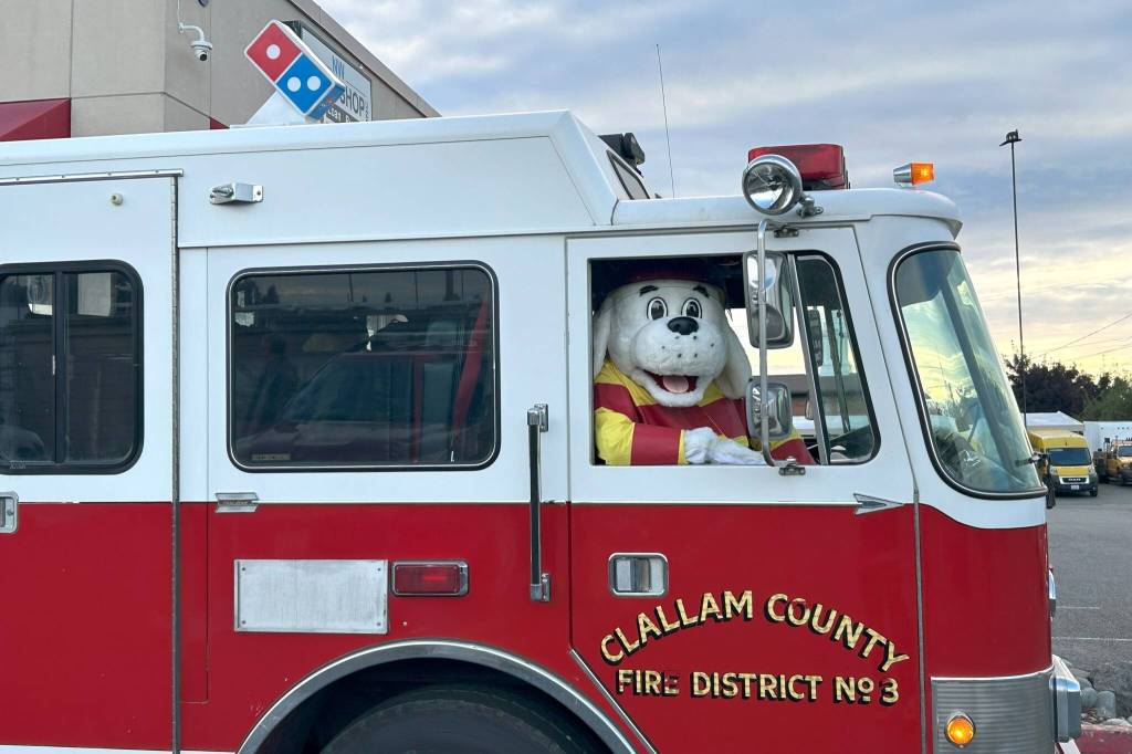 Sequim Gazette photo by Matthew Nash/
Sparky the Fire Dog awaits a call for pizza on Oct. 8. He and career and volunteer firefighters with Clallam County Fire District 3 drove to participating homes to check smoke alarms, and if they worked, then the household would receive free pizza.
Sequim Gazette photo by Matthew Nash/
Sparky the Fire Dog awaits a call for pizza on Oct. 8. He and career and volunteer firefighters with Clallam County Fire District 3 drove to participating homes to check smoke alarms, and if they worked, then the household would receive free pizza.