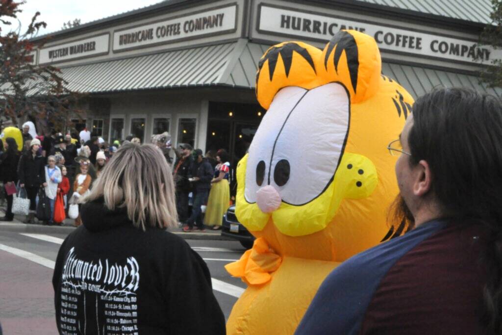 Sequim Gazette file photo by Matthew Nash/
An inflatable Garfield awaits the stoplight change at Centennial Place on Halloween in downtown Sequim in 2024. Downtown merchants host trick-or-treating from 3-5 p.m. on Halloween.