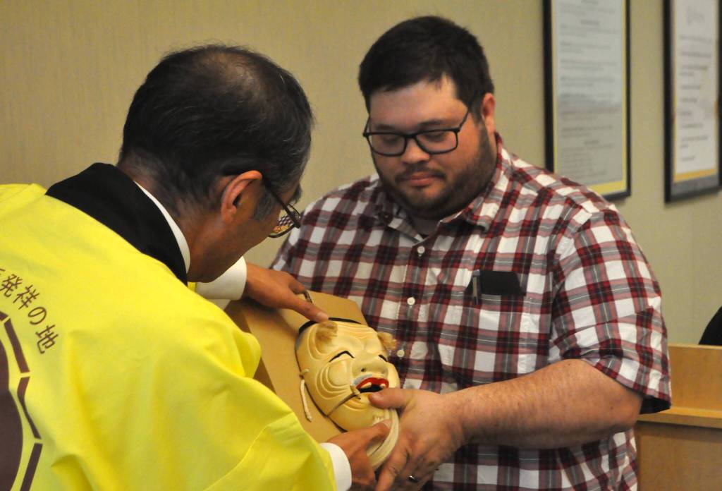 Sequim Gazette photo by Matthew Nash/
Shiso City Deputy Mayor Kenji Tomita presents Sequim Mayor Brandon Janisse one of three masks during the Oct. 13 Sequim City Council meeting. The traditional Japanese performing arts masks represent friendship, connection and happiness and will be in the Sister City display case with more detailed information inside the Sequim Civic Center in the near future, staff said.