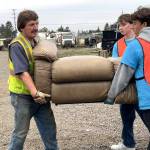 Sequim Gazette photos by Matthew Nash
Gary Myer, a Sequim maintenance worker, works with Sequim High School Interact Club members John Pehrson, president, and Nico Musso, photographer, to move a couch during Rally in the Alley on Oct. 18. Local residents dropped off unwanted items for free at the City Shop and Carrie Blake Community Park.