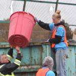 Keylee Disinksi, a Sequim High School senior and member of the Interact Club, helps Gary Butler, a Sequim parks maintenance worker, fill a dumpster for Rally in the Alley in Carrie Blake Community Park. Disinksi said she has helped for two years and enjoys helping the community.