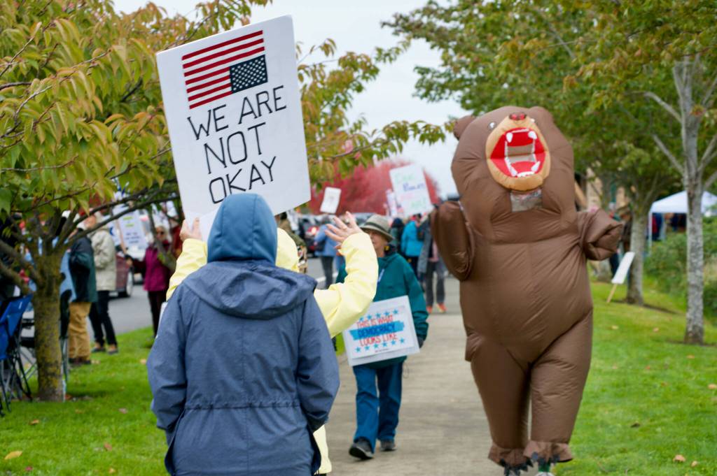 Sequim Gazette photo by Jacques Star/
Many of those who participated in the No Kings II demonstration on Saturday, Oct. 18 carried signs. Some even wore costumes.