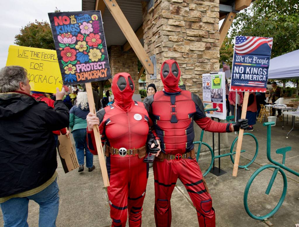 Sequim Gazette photo by Jacques Star/
A couple of Deadpools join the No Kings II demonstration on Saturday.