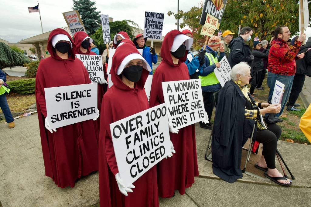 Sequim Gazette photo by Jacques Star/ 
Some participants in the No Kings II protest in Sequim wore Handmaids Tale costumes to draw attention to threats against womens rights.