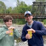 Photo courtesy Dungeness River Nature Center
Michael Glore and his daughter Darcy get ready to release salmon fry into the Dungeness River during a community program in 2023. Glore, the new executive director of the Dungeness River Nature Center, said this moment reminded him of the power of nature to open hearts, change perspectives, and bring people closer together, and was a driving inspiration for him to apply at the center.
