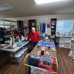 Photo by Reba Renner/ Judy Lange stands in the craft store at the Shipley Center amid items made by the fiber arts group she leads. Items from the store will be sold at the Shipley Center Holiday Bazaar scheduled for Nov. 7-8.