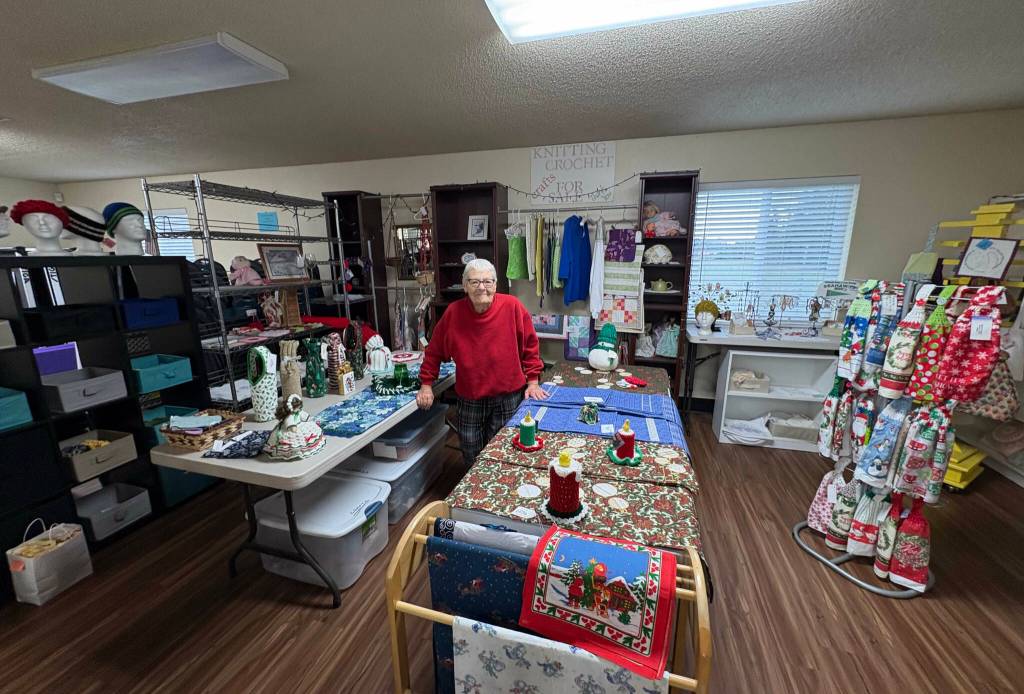 Photo by Reba Renner/ Judy Lange stands in the craft store at the Shipley Center amid items made by the fiber arts group she leads. Items from the store will be sold at the Shipley Center Holiday Bazaar scheduled for Nov. 7-8.