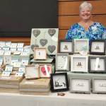 Photo courtesy Catherine Lanham/ Catherine Lanham poses with some of the sea glass jewelry and shadow box art that she sells at her C Glass table at the Shipley Center Holiday Bazaar.
