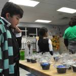 Sequim Gazette photo by Matthew Nash/
Lucca Trevino, 10, dressed as Tanjiro Kamado from Demon Slayer, carefully selects the treat he won in the Cake Walk during the Sequim Boys & Girls Clubs Halloween Bash.