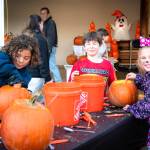 Photo by Monica Berkseth/
Children carve pumpkins on Oct. 25 at the Sequim Prairie Granges Country Fair and Trunk-or-Treat.