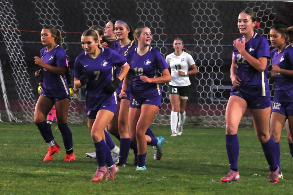 Kaiya Robinson (10) celebrates with teammates after scoring a goal against Port Angeles on Oct. 21.