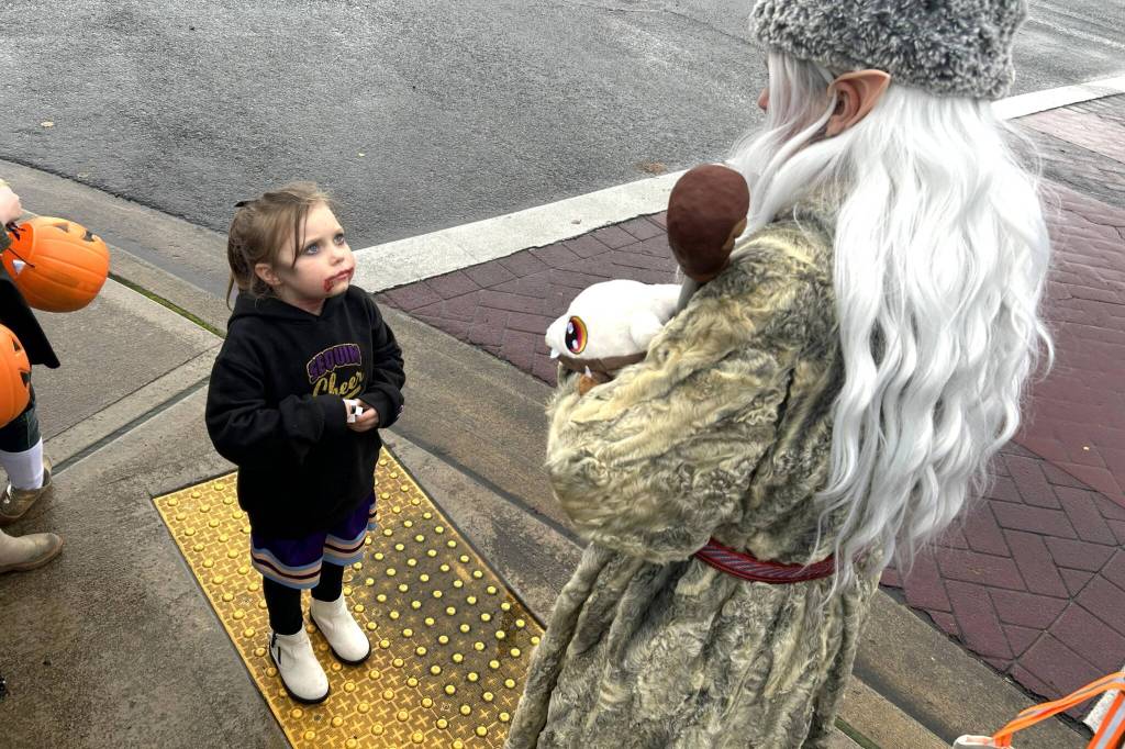 Sequim Gazette photo by Matthew Nash
Five-year-old Mera Holland, dressed as a bloody cheerleader, chats with one of the many costumed characters on Halloween in downtown Sequim.