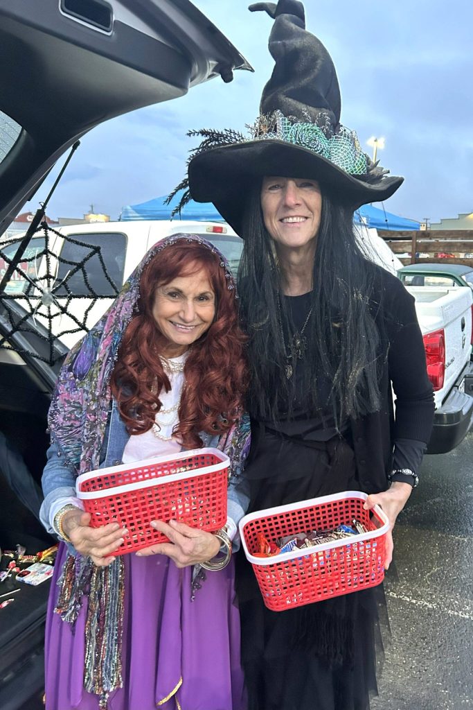 Sequim Gazette photo by Matthew Nash/
Josie Smith, left, as a fortune teller, and Brenda Wilson as a witch hand out candy at the Olympic Peninsula Rat Racers trunk-or-treat on Oct. 31. They participate in the event each year, they said.