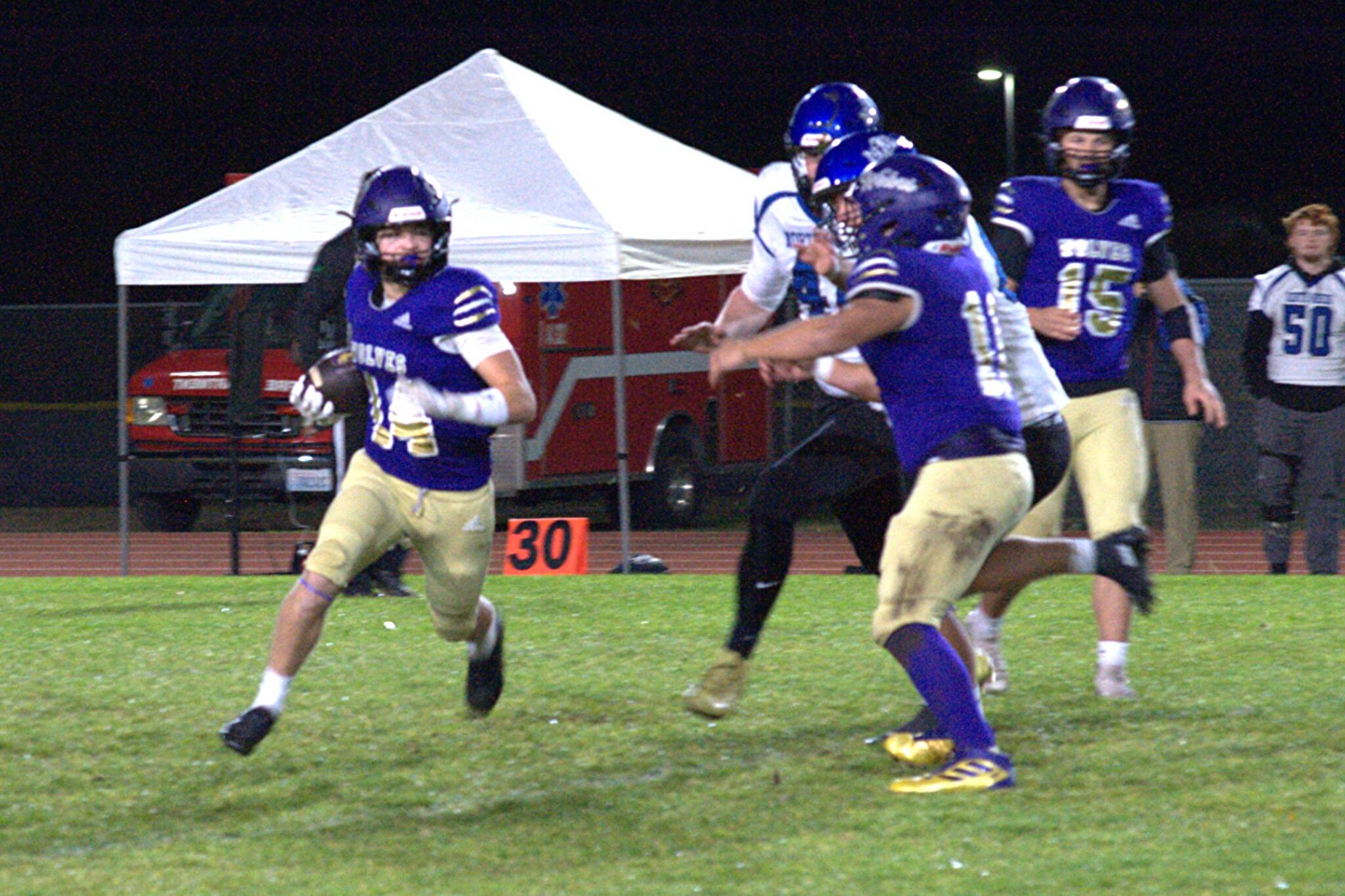 Sequim Gazette photo by Matthew Nash
Sequims Zeke Schmadeke carries the ball as teammate Liam Wiker provides a seal block during the Wolves 37-23 loss to North Mason on Oct. 30.