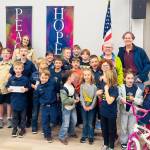 Photo courtesy OPBA
Olympic Peninsula Bicycle Association (OPBA) members, on top right, Jean Robards and Frank Finney present a grant worth $3,969 to Sequim Cub Scout Pack 4490 led by Pack Leader Fran Olsen and scouts. The Scout Pack also received equipment for the Sequim Bike Rodeo to continue the educational event.